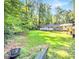 Lush backyard with seating and mature trees, offering a private outdoor retreat at 1445 Woodhill Dr, Marietta, GA 30066