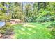 Expansive backyard surrounded by mature trees, providing ample space and privacy at 1445 Woodhill Dr, Marietta, GA 30066