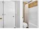 Clean bathroom featuring a shower-tub combo, with tile accent wall and a modern toilet at 1445 Woodhill Dr, Marietta, GA 30066
