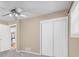 Neutral bedroom featuring a ceiling fan, carpet flooring, and double door closet at 1445 Woodhill Dr, Marietta, GA 30066