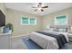 Bright bedroom with neutral walls, carpet flooring, two windows, and ceiling fan at 1445 Woodhill Dr, Marietta, GA 30066