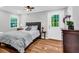 Comfortable bedroom with hardwood floors, natural light, and private access at 1445 Woodhill Dr, Marietta, GA 30066