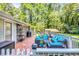 Inviting deck area featuring stylish outdoor furniture, grill, and access to a lush yard at 1445 Woodhill Dr, Marietta, GA 30066