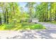 Inviting home nestled in a wooded setting, featuring a charming front exterior and a long, private driveway at 1445 Woodhill Dr, Marietta, GA 30066