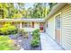 Welcoming entrance with a red front door, brick accents, and a garden leading to the home at 1445 Woodhill Dr, Marietta, GA 30066