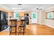 Open kitchen with an island, wood cabinets, black appliances, and access to the backyard, perfect for entertaining at 1445 Woodhill Dr, Marietta, GA 30066