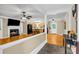 Open-concept living and kitchen space with hardwood floors and a fireplace, creating a warm and inviting atmosphere at 1445 Woodhill Dr, Marietta, GA 30066