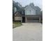 Charming two-story home featuring a two-car garage, brick accents, and a well-maintained front yard at 1910 Glynmoore Dr, Lawrenceville, GA 30043