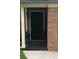 Inviting front door entrance with brick surround, decorative columns, and potted plants at 1910 Glynmoore Dr, Lawrenceville, GA 30043
