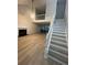 Open-concept living area with fireplace, stairs, and wood floors providing a modern feel at 1910 Glynmoore Dr, Lawrenceville, GA 30043