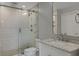 Modern bathroom featuring a glass-enclosed shower, marble countertop, and sleek fixtures at 361 17Th St # 910, Atlanta, GA 30363