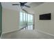Well-lit bedroom with large windows, plush carpet, and a wall-mounted TV for relaxing evenings at 361 17Th St # 910, Atlanta, GA 30363