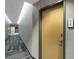 Hallway outside unit 910, with patterned grey carpet, and modern door at 361 17Th St # 910, Atlanta, GA 30363
