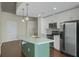 Bright kitchen featuring stainless steel appliances, an island with a sink, and white cabinets, perfect for modern living at 361 17Th St # 910, Atlanta, GA 30363