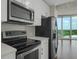 Modern kitchen design featuring stainless steel appliances, white cabinets and countertop, and a black refrigerator at 361 17Th St # 910, Atlanta, GA 30363