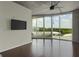Open living room with hardwood floors, large windows with great views, and a wall-mounted TV at 361 17Th St # 910, Atlanta, GA 30363