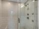 Walk-in shower features white subway tile, with herringbone tile accent and shower bench at 361 17Th St # 910, Atlanta, GA 30363