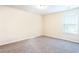 A bright bedroom features neutral walls, carpet, and a large window offering natural light at 4628 Mcever View Dr, Sugar Hill, GA 30518