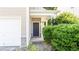 Close-up of front entrance with well maintained landscaping, covered entry and stone accents at 4628 Mcever View Dr, Sugar Hill, GA 30518