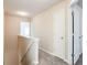 Upstairs hallway with carpet, neutral walls, and white trim, plus two white doors at 4628 Mcever View Dr, Sugar Hill, GA 30518
