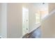 Light-filled hallway with wood-look floors and trim, and view of an open doorway at 4628 Mcever View Dr, Sugar Hill, GA 30518