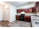 Functional kitchen featuring dark wood cabinets, modern appliances, and ample counter space at 4628 Mcever View Dr, Sugar Hill, GA 30518