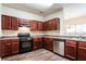 Well-lit kitchen with dark wood cabinetry, stainless steel appliances, and a modern aesthetic at 4628 Mcever View Dr, Sugar Hill, GA 30518