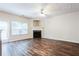 Living room featuring hardwood flooring, fireplace, and lots of natural light at 4628 Mcever View Dr, Sugar Hill, GA 30518