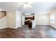 Open-concept living space with hardwood flooring, and a view of the kitchen and dining area at 4628 Mcever View Dr, Sugar Hill, GA 30518