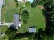 Aerial view of the property showing a large yard, detached garage, and proximity to wooded areas at 2081 Old Peachtree Road Northeast Rd, Lawrenceville, GA 30043