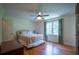 Bright bedroom with hardwood floors, a ceiling fan, and a large window providing natural light at 2081 Old Peachtree Road Northeast Rd, Lawrenceville, GA 30043