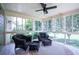 Inviting screened porch with comfortable wicker furniture, perfect for enjoying the outdoors at 2081 Old Peachtree Road Northeast Rd, Lawrenceville, GA 30043
