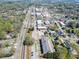 Aerial view of the community shows the surrounding neighborhood and train tracks at 130 W Main Street # 1, Buford, GA 30518