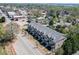 Aerial view of townhome community with mature trees along the street at 130 W Main Street # 1, Buford, GA 30518