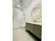 Modern bathroom features a walk-in shower with glass door, hexagon tile floor, and round mirror at 130 W Main Street # 1, Buford, GA 30518