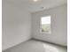 Well-lit bedroom with large window, plush carpet, and neutral walls at 130 W Main Street # 1, Buford, GA 30518