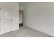 Comfortable bedroom featuring plush carpeting and an open doorway with a closet at 130 W Main Street # 1, Buford, GA 30518