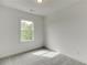 Bright bedroom with a window and neutral carpet that lets in natural light at 130 W Main Street # 1, Buford, GA 30518
