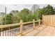 This wood deck has views of the neighborhood and features a wooden railing with black spindles at 130 W Main Street # 1, Buford, GA 30518