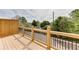 This wooden deck has a wooden and black metal railing providing privacy and neighborhood views at 130 W Main Street # 1, Buford, GA 30518