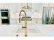 Close-up of kitchen featuring a chef-style range, stainless steel appliances, and gold water tap at 130 W Main Street # 1, Buford, GA 30518
