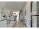 Open-concept living area with hardwood floors, modern lighting, and seamless flow to the kitchen at 130 W Main Street # 1, Buford, GA 30518
