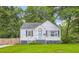 Charming brick home featuring a well-manicured lawn, blue shutters, and a cozy front porch, nestled among mature trees at 512 Allendale Dr, Decatur, GA 30032
