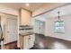 Open kitchen and dining area with dark hardwood floors and stylish light fixture at 512 Allendale Dr, Decatur, GA 30032