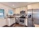Efficient kitchen featuring stainless steel appliances, stylish backsplash, and ample counter space for cooking at 512 Allendale Dr, Decatur, GA 30032