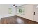 Bright living room with hardwood floors, ceiling fan and natural light streaming through the windows at 512 Allendale Dr, Decatur, GA 30032