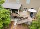 Backyard view featuring a multi-level deck with an outdoor seating area and grilling space at 5473 Heatherbrooke Nw Dr, Acworth, GA 30101