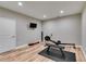 Finished basement exercise room featuring wood-look flooring, neutral walls, and gym equipment at 5473 Heatherbrooke Nw Dr, Acworth, GA 30101