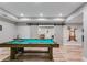 Finished basement featuring a pool table with sliding barn doors to another room at 5473 Heatherbrooke Nw Dr, Acworth, GA 30101