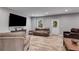 Finished basement with comfortable seating, a large TV, and stylish wood-look flooring at 5473 Heatherbrooke Nw Dr, Acworth, GA 30101